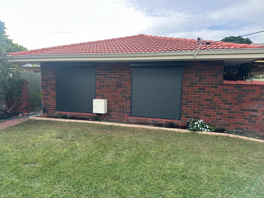Dark grey roller shutters installed on the front windows